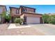 Inviting two-story home featuring a desert landscape and a two car garage at 1017 W Lydia Ln, Phoenix, AZ 85041