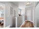 Hallway with hardwood floors, leading to the bedrooms, and lots of natural light at 1017 W Lydia Ln, Phoenix, AZ 85041