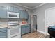 Kitchen features white appliances, including a stove, microwave, and stainless steel refrigerator at 1017 W Lydia Ln, Phoenix, AZ 85041