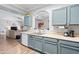 Kitchen view with light blue cabinets and stainless steel sink, with pass-through window at 1017 W Lydia Ln, Phoenix, AZ 85041