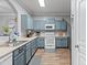 Beautiful kitchen with light blue cabinets, modern appliances and plenty of counter space at 1017 W Lydia Ln, Phoenix, AZ 85041