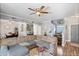 Spacious living room featuring modern decor, ceiling fan and wood-look floors at 1017 W Lydia Ln, Phoenix, AZ 85041