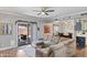 Inviting living room featuring wood-look floors and sliding glass door to patio at 1017 W Lydia Ln, Phoenix, AZ 85041