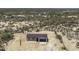 An aerial view shows this single-Gathering home surrounded by desert vegetation and other structures at 10772 N Biznaga St, Florence, AZ 85132
