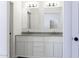 This bathroom features a double vanity sink, granite countertops, and classic white cabinets at 10772 N Biznaga St, Florence, AZ 85132