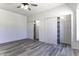 This bedroom has gray vinyl floors and dual closets at 10772 N Biznaga St, Florence, AZ 85132