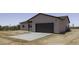 The home showcases a covered entry and two-car garage, complemented by the natural desert landscape at 10772 N Biznaga St, Florence, AZ 85132