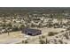 Aerial view of a desert property featuring a charming single-story home with an attached two car garage and a long driveway at 10772 N Biznaga St, Florence, AZ 85132