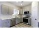 The kitchen boasts sleek gray cabinetry, stainless steel appliances, and modern countertops at 10772 N Biznaga St, Florence, AZ 85132