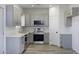 This kitchen features modern gray cabinets, stainless steel appliances, and beautiful marble-look countertops at 10772 N Biznaga St, Florence, AZ 85132