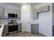 This kitchen features modern gray cabinets, stainless steel appliances, and beautiful marble-look countertops at 10772 N Biznaga St, Florence, AZ 85132