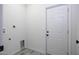 Laundry room with laminate flooring and access door at 10772 N Biznaga St, Florence, AZ 85132