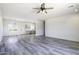 This spacious living room offers gray-toned laminate flooring, ample lighting, and desert views at 10772 N Biznaga St, Florence, AZ 85132