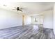 The living room features gray-toned laminate flooring, a ceiling fan, and neutral colored walls at 10772 N Biznaga St, Florence, AZ 85132