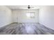 Bright living room features gray-toned laminate flooring, neutral walls, and desert landscape views at 10772 N Biznaga St, Florence, AZ 85132