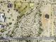 Aerial view of a desert property outlined in yellow, featuring a single-Gathering home, horse stables and expansive surrounding area at 10772 N Biznaga St, Florence, AZ 85132