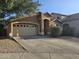 Charming single-story home featuring a two-car garage, desert landscaping, and a welcoming front porch at 1309 E Julie Ct, San Tan Valley, AZ 85140