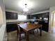 The kitchen features a table, tiled floor, and dark cabinets at 1309 E Julie Ct, San Tan Valley, AZ 85140