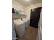 Laundry room with washer, dryer, storage shelf, and tile flooring at 1309 E Julie Ct, San Tan Valley, AZ 85140
