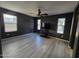 Bright living room with gray walls, wood-look flooring, ceiling fan, and natural light at 1309 E Julie Ct, San Tan Valley, AZ 85140