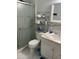Well-lit bathroom features a glass shower door, modern fixtures, and storage shelving at 1417 E Century Ave, Gilbert, AZ 85296