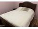 Simple bedroom with a comfortable bed, soft lighting, and hardwood flooring at 1417 E Century Ave, Gilbert, AZ 85296