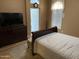 Comfortable bedroom featuring a dresser, TV, and an open doorway for natural light at 1417 E Century Ave, Gilbert, AZ 85296