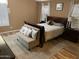 Inviting bedroom with warm tones, wood floors, accent pillows, and bench seating at 1417 E Century Ave, Gilbert, AZ 85296