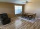 Inviting dining room featuring wood-look floors, modern table set, and natural light at 1417 E Century Ave, Gilbert, AZ 85296