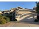 Charming single-story home featuring a two-car garage, desert landscaping, and tile roofing at 1417 E Century Ave, Gilbert, AZ 85296