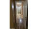 Long hallway showing the wood look floors leading into the house with doors on either side at 1417 E Century Ave, Gilbert, AZ 85296