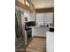 Bright kitchen with modern stainless appliances, light countertops, and wood-look flooring at 1417 E Century Ave, Gilbert, AZ 85296