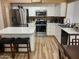 Bright kitchen featuring stainless steel appliances, a breakfast bar, and white cabinets at 1417 E Century Ave, Gilbert, AZ 85296
