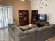 Comfortable living room features hardwood floors, wooden shelving, and a sliding glass door for natural light at 1417 E Century Ave, Gilbert, AZ 85296