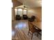 Open-concept living area boasts wood floors, ceiling fan, and natural light from large windows at 1417 E Century Ave, Gilbert, AZ 85296