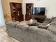 Cozy living room with a plush sofa, hardwood floors, and wooden shelving, perfect for relaxing at 1417 E Century Ave, Gilbert, AZ 85296
