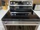 Close-up of a modern electric stove and oven featuring stainless steel trim and a black cooktop at 1417 E Century Ave, Gilbert, AZ 85296