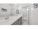 Bright bathroom with a double sink vanity, large mirror, and a separate shower room at 14870 W Encanto Blvd # 1059, Goodyear, AZ 85395