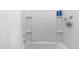 Clean, well-maintained bathtub and shower combination with tiled walls and built-in shelving at 14870 W Encanto Blvd # 1059, Goodyear, AZ 85395