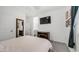 Well-lit bedroom featuring neutral colors, a large television, and coordinated furnishings at 14870 W Encanto Blvd # 1059, Goodyear, AZ 85395