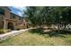 Well-maintained exterior with lush green lawn, walkway, and mature trees at 14870 W Encanto Blvd # 1059, Goodyear, AZ 85395