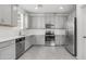Well-lit kitchen with stainless steel appliances, grey cabinets, and stylish countertops, perfect for cooking at 14870 W Encanto Blvd # 1059, Goodyear, AZ 85395