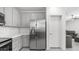 Modern kitchen featuring stainless steel refrigerator, white countertops and grey cabinets at 14870 W Encanto Blvd # 1059, Goodyear, AZ 85395