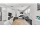 Open-concept living area with modern furnishings, light walls, and a seamless flow into the dining area at 14870 W Encanto Blvd # 1059, Goodyear, AZ 85395