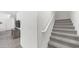 Carpeted staircase with white banister and view to the living area at 14870 W Encanto Blvd # 1059, Goodyear, AZ 85395