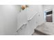 Carpeted staircase with white banister and view of the upstairs bedroom at 14870 W Encanto Blvd # 1059, Goodyear, AZ 85395