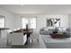 Open-concept living room featuring sleek furniture, modern artwork and dining table, perfect for entertaining at 15508 W Corte Del Sol Este --, Waddell, AZ 85355