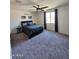 Bright bedroom with a ceiling fan, plush carpet, and natural light from a large window at 1630 E Prickly Pear Pl, Casa Grande, AZ 85122