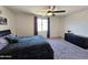Comfortable bedroom with plush carpet, a ceiling fan, and ample space at 1630 E Prickly Pear Pl, Casa Grande, AZ 85122