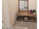 Entryway area with a wooden bench and mirror, creating a convenient spot for storing shoes and accessories at 1630 E Prickly Pear Pl, Casa Grande, AZ 85122